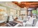 Large screened porch featuring wood ceilings, ceiling fans, comfortable seating and a dining space at 1894 Whitehawk Ct, Lawrenceville, GA 30043
