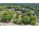 Aerial shot showcasing a neighborhood surrounded by lush trees and greenery with a blue sky overhead at 2301 Sharon Se Ct, Conyers, GA 30013