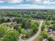This aerial shot features a scenic neighborhood with tree-lined streets and sprawling green spaces at 2301 Sharon Se Ct, Conyers, GA 30013