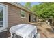 The wooden back deck includes chairs, table and grill with a backyard view at 2301 Sharon Se Ct, Conyers, GA 30013