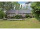 The large backyard features a wood pile and the back of the home at 2301 Sharon Se Ct, Conyers, GA 30013