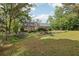Large grassy backyard with mature trees, providing ample space for outdoor activities at 2301 Sharon Se Ct, Conyers, GA 30013