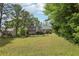 A spacious green backyard featuring a home and surrounding trees, providing a serene environment at 2301 Sharon Se Ct, Conyers, GA 30013
