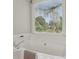A bathtub with chrome fixtures sits near a window, providing a bright and serene bathing experience at 2301 Sharon Se Ct, Conyers, GA 30013