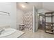 A bright bathroom features a shower with a patterned curtain, a sink, and tile floors at 2301 Sharon Se Ct, Conyers, GA 30013