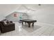 Large bonus room with a pool table, a leather couch, tile flooring, and angled ceilings at 2301 Sharon Se Ct, Conyers, GA 30013