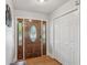 Entryway showcasing a wooden front door with sidelights, hardwood floors, and a closet providing ample storage space at 2301 Sharon Se Ct, Conyers, GA 30013