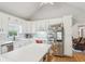 White kitchen offering hardwood floors, plentiful cabinetry, stainless steel appliances, and views to the living space at 2301 Sharon Se Ct, Conyers, GA 30013
