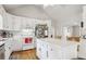 Bright kitchen featuring white cabinets, a spacious center island, and modern appliances complementing the hardwood floors at 2301 Sharon Se Ct, Conyers, GA 30013