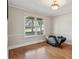 Living room with hardwood floors, large windows providing natural light, and chair rail adding architectural detail at 2301 Sharon Se Ct, Conyers, GA 30013
