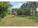 Expansive lot featuring a well-maintained lawn, mature trees, and a charming home in the background at 2301 Sharon Se Ct, Conyers, GA 30013
