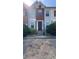 Townhouse with a red brick facade, neutral siding, and a well-maintained lawn and dark front door at 2896 Vining Ridge Ter, Decatur, GA 30034