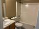 A full bathroom with a shower and tub, toilet, sink, and wooden vanity at 4234 Winston Cir, Atlanta, GA 30349