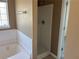 This bathroom features a bathtub, separate shower, neutral-toned walls and traditional fixtures at 4234 Winston Cir, Atlanta, GA 30349