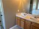 This bathroom offers a double sink vanity with laminate countertop and wood cabinets, and a large mirror at 4234 Winston Cir, Atlanta, GA 30349