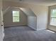 Angled walls meet at the window of this bedroom featuring gray carpet at 4234 Winston Cir, Atlanta, GA 30349