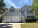 Charming two-story home featuring a two-car garage, beautiful architectural features, and manicured landscaping at 4234 Winston Cir, Atlanta, GA 30349