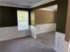 Open-concept living room featuring neutral carpet, classic wainscoting, and natural light at 4234 Winston Cir, Atlanta, GA 30349