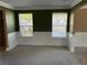 Inviting living room featuring carpet, classic wainscoting, and plenty of natural light at 4234 Winston Cir, Atlanta, GA 30349