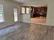 Open-concept living room with hardwood floors, a kitchen view, and natural light at 4234 Winston Cir, Atlanta, GA 30349