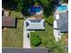Aerial view of home with solar panels, deck and in-ground pool in a lush, green neighborhood at 724 Camelot Way, Norcross, GA 30071