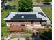 Aerial view of home with solar panels, wooden deck, and inviting outdoor patio at 724 Camelot Way, Norcross, GA 30071
