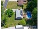 Aerial view of a home featuring a large yard, solar panels, and an outdoor pool at 724 Camelot Way, Norcross, GA 30071