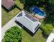 Aerial view of home featuring solar panels, an in-ground pool, and a mature tree-lined yard at 724 Camelot Way, Norcross, GA 30071