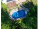 Overhead view of the in-ground pool with a concrete surround and mature trees providing shade at 724 Camelot Way, Norcross, GA 30071