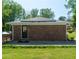 Brick house featuring solar panels on the roof and a concrete patio at 724 Camelot Way, Norcross, GA 30071