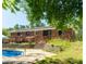 Charming backyard featuring a wooden deck, stone steps, and a refreshing in-ground swimming pool at 724 Camelot Way, Norcross, GA 30071