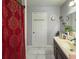 Bright bathroom with marble tile flooring, sink, and decorative red shower curtain at 724 Camelot Way, Norcross, GA 30071