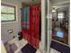 Bathroom featuring tiled floors, toilet, decorative curtains, and natural light at 724 Camelot Way, Norcross, GA 30071