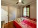 Comfortable bedroom with hardwood flooring, natural light, and a spacious closet at 724 Camelot Way, Norcross, GA 30071