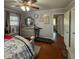 Bedroom featuring hardwood floors, a treadmill, and matching dresser at 724 Camelot Way, Norcross, GA 30071