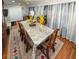 Spacious dining room with a large dining table and patterned rug on hardwood floors at 724 Camelot Way, Norcross, GA 30071