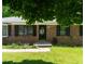 Brick home featuring a welcoming front entrance and manicured lawn at 724 Camelot Way, Norcross, GA 30071