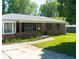Well-maintained brick home with a bay window and a lush green lawn at 724 Camelot Way, Norcross, GA 30071