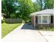 This brick home has a charming bay window and well-maintained landscaping at 724 Camelot Way, Norcross, GA 30071