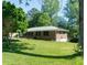 Well-maintained brick home with a lush green lawn and mature trees in a quiet setting at 724 Camelot Way, Norcross, GA 30071