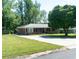 Charming brick home featuring a well-manicured lawn and a long driveway at 724 Camelot Way, Norcross, GA 30071