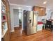 Well-lit eat-in kitchen with wood floors, a stainless steel refrigerator, and ample cabinet space at 724 Camelot Way, Norcross, GA 30071