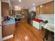 Spacious kitchen with wood floors, a stainless steel refrigerator, and ample cabinetry at 724 Camelot Way, Norcross, GA 30071