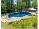 Enjoy the outdoors with this inviting swimming pool surrounded by lush greenery and a shed at 724 Camelot Way, Norcross, GA 30071