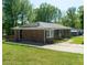This brick home is equipped with solar panels on the roof and a lush yard at 724 Camelot Way, Norcross, GA 30071