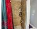 Bathroom shower with brown tile, decorative curtains, and a corner shower caddy at 724 Camelot Way, Norcross, GA 30071
