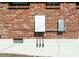 Exterior shows a Tesla Powerwall installed on the brick home providing energy storage solutions at 724 Camelot Way, Norcross, GA 30071