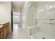 Modern bathroom featuring a glass-enclosed shower with built-in seat and a vanity with granite countertop at 1410 Bluestone Dr, Cumming, GA 30041