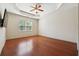 Spacious bedroom with hardwood floors, a ceiling fan, and a large window allowing natural light at 1410 Bluestone Dr, Cumming, GA 30041