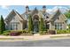Exterior view of the community clubhouse entrance with manicured landscaping at 1410 Bluestone Dr, Cumming, GA 30041